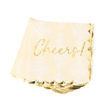 A stack of square paper party napkins in a warm cream color with a white damask pattern and metallic gold foil writing that says 'Cheers!'.