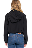 Back of a black lightweight hooded jacket