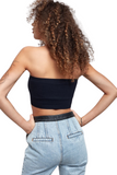 back of woman wearing a black cropped tube top with denim pants that have a black leather waistband 