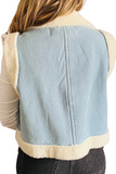 back of a light denim vest with sherpa lining. The vest has sherpa detailing around the edges