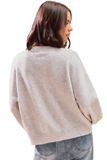 Back view of light gray flower embroidered sweater showing plain back and relaxed fit.