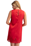 A woman shown from the back wearing a sleeveless red dress with a lace hem, photographed against a plain white studio background.