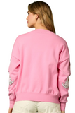 Back of a pink button down cardigan 