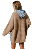 Back of a tan oversized cardigan with a denim checkered hood and pocket