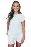 Woman wearing a white t-shirt and shorts set on a white background