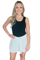 woman wearing a black crew neck basic tank top with a white pleated shirt 