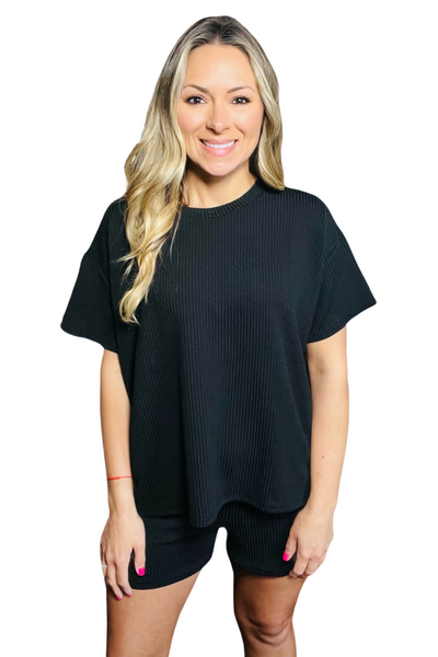 woman wearing black corded crew neck short sleeve shirt with matching black shorts 