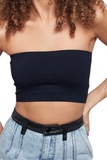 woman wearing a black cropped tube top with denim pants that have a black leather waistband and belt loops 