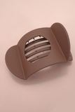 Brown lay flat hair claw clip with minimalist curved design and matte finish for secure, comfortable all day styling