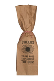 A brown kraft paper gift bag tied with a red-and-white string, printed with the word 'CHEERS' and a black sun graphic above the text 'TO ONE MORE TRIP AROUND THE SUN!' on a white background.
