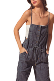 Up close photo of a woman wearing denim utility denim overalls. Overalls are a dark denim with a square neckline, adjustable spaghetti straps, 2 front breast pockets, functional front buttons, utility pockets and a functional tie belt 