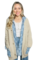 woman wearing a checkered denim jacket with a tan colored cardigan sweater 