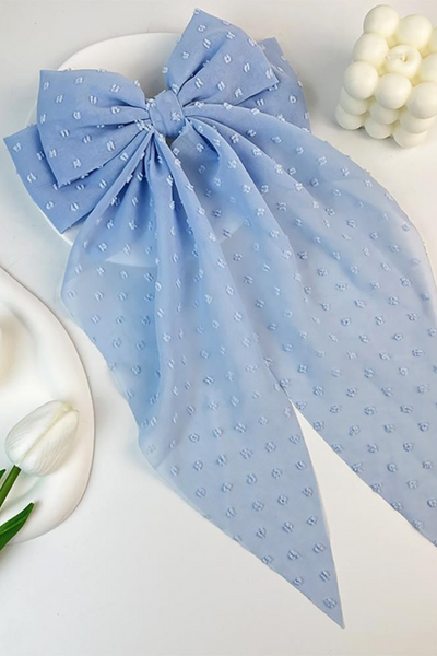 Oversized powder blue hair bow. Bow is a sheer material with embroidered dot detailing 