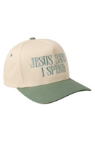 Cream and sage green trucker hat with a sage bill, sage squatchee, and matching sage eyelets. The front features embroidered teal text that reads, “JESUS SAVES I SPEND.”