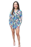 Woman wearing a floral long sleeve button down shirt dress 