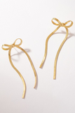 Gold herringbone long bow earrings. 
