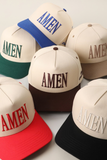 Collection of baseball caps with 'AMEN' text in various colors on a light background