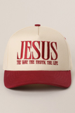A baseball cap with an off-white crown and a dark red brim, featuring the word 'JESUS' embroidered in dark red on the front, with the phrase 'THE WAY. THE TRUTH.