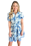 Woman wearing a collared button down two toned landscape print dress