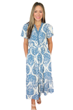 A woman modeling a short-sleeve V-neck maxi dress with a blue and white paisley pattern, standing against a solid white background.