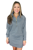 A woman modeling a navy and white gingham check long-sleeve quarter-zip pullover dress with a mock neck and a matching mini skirt, set against a plain white background.