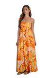 Woman wearing an orange and yellow patterned dress on a white background