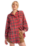 woman wearing an oversized red plaid flannel shirt with a dark tan mini skirt