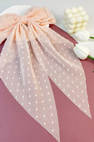 Oversized powder pink hair bow. Bow is a sheer material with embroidered dot detailing 