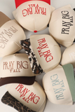 Pray Big Y’all embroidered trucker hats in multiple colors styled together for Christian apparel, inspirational accessories, and faith based fashion