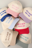 photo of 7 hats 2 tone 5 panel trucker hats, hats are embroidered with "put it on my dads tab" on the front panel. Hats are ivory with colored bill and stitching. Colors front top to bottom: Blue, light pink, lilac, baby blue, hot pink, tan, light green