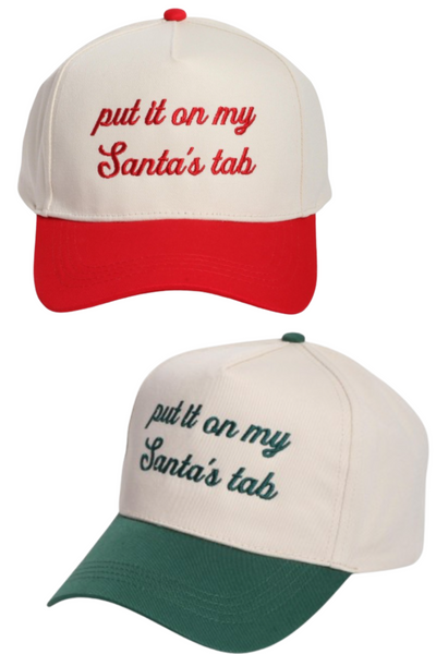 Cream trucker hat available with a red bill and squatchee or green bill and squatchee. Both feature embroidered script text on the front that reads, “put it on my Santa’s tab.”