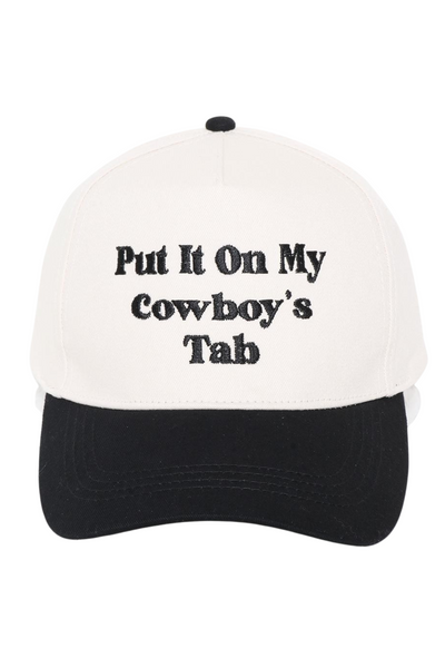 White baseball cap with a black bill, "Put It On My Cowboy's Tab" is embroidered on the front center of the hat