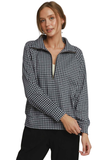 A woman modeling a black and white gingham long-sleeve quarter-zip pullover with a stand collar, paired with black pants, against a plain white background.