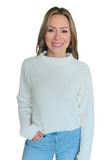 Woman wearing a cozy ivory sweater with jeans 
