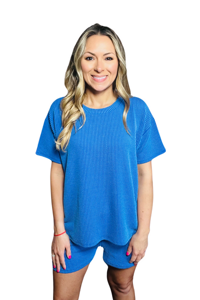 woman wearing a royal blue corded crewneck short sleeve shirt with matching corded royal blue shorts