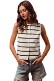 woman wearing a short sleeve black and white striped sweater with functional buttons down the front, front has a split hem in the front. Woman has it paired with distressed denim shorts