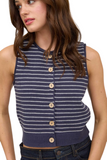 woman wearing a navy blue button-down sweater vest with white stripes and wooden functional buttons. Sweater has a ribbed hemline, round neckline and a raw hem detail on the neck and sleeve. Vest is paired with dark blue denim 