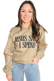 Woman wearing at an long sleeve crewneck sweatshirt with “Jesus Saves I Spend” printed in black on the front.