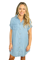 woman wearing a collared denim button down shirt dress, dress has a front pocket 