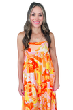 Woman wearing a colorful dress with abstract patterns on a white background