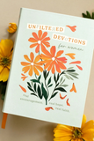 A book titled 'Unfiltered Devotions for Women' with a light blue cover, decorated with orange and yellow flowers and green leaves, styled with yellow flowers on a beige background.