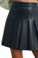 Close-up view of a black pleated faux leather mini skirt with a high-waist design, showing the structured pleats and smooth leather texture.
