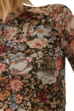 Upclose photo of a knit semi sheer floral top 