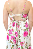 Picture of the back of a spaghetti strap ivory jumpsuit with a pink floral print. Back features an elastic band with a cutout and tie beneath the sqaure cut out 