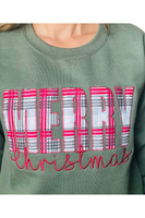 Upclose photo of an olive green sweatshirt with MERRY in a patch and Christmas in a scripted embroidered font.