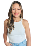 woman wearing a white ribbed round halter neck tank top with a pair of denim pants