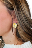 geometric shaped earrings with a yellow, navy and white moroccan print on a woman's ear