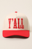 A baseball cap with an off-white crown and a red brim, featuring the word 'Y'ALL' embroidered in red across the front.