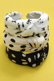 Knotted headbands in polka dot and bow print designs stacked together