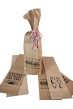 Brown kraft paper party favor bags tied with red and white striped string, printed with black text and graphics, arranged on a white background.